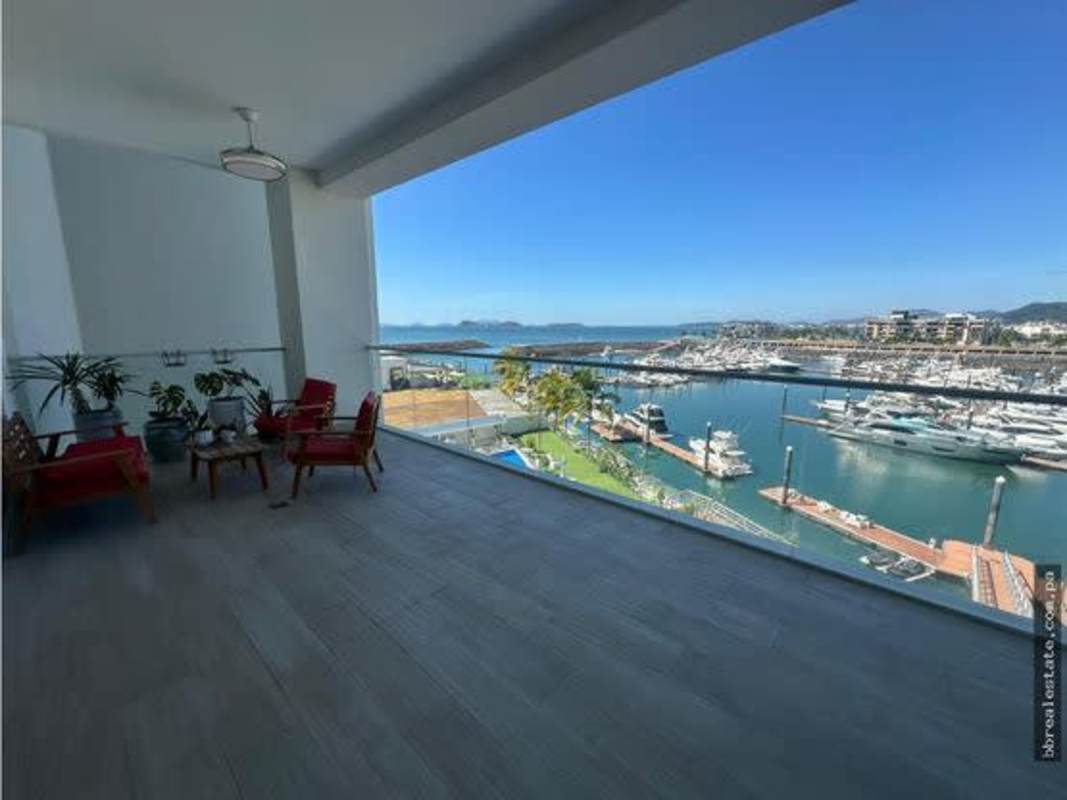 Master bedroom with floor-to-ceiling windows, ocean view and ensuite bath in Ocean Reef Island condo