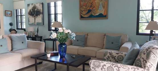 Contemporary living room with large windows and modern furniture in estate home San Carlos Panama