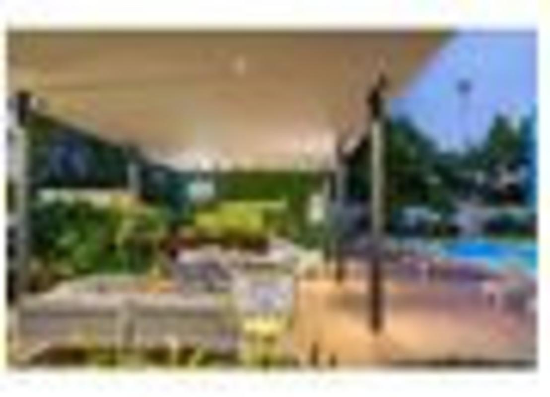 Patio lounge area with pool and greenery PH Regent Costa del Este Panama