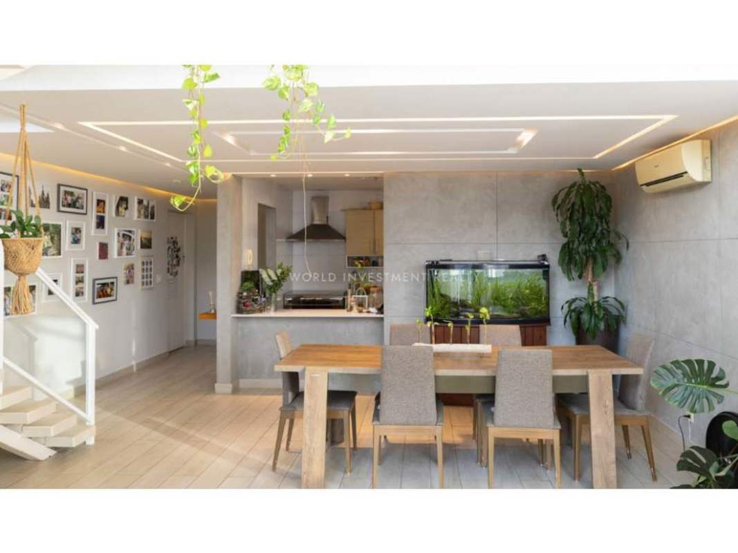 Contemporary kitchen with stainless steel appliances in loft apartment Bella Vista