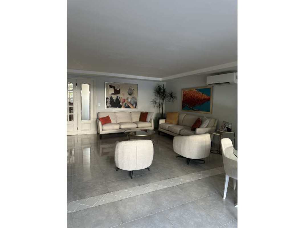 Large living room with modern furniture and garden views in Altos del Golf house Panama City