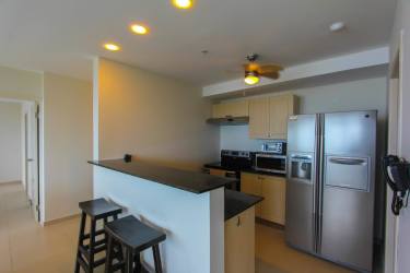 Open-concept dining living room with floor-to-ceiling windows oceanfront PH Coronado Bay Panama