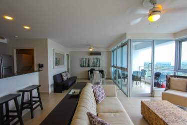 Modern living room with panoramic windows and balcony overlooking the ocean at PH Coronado Bay