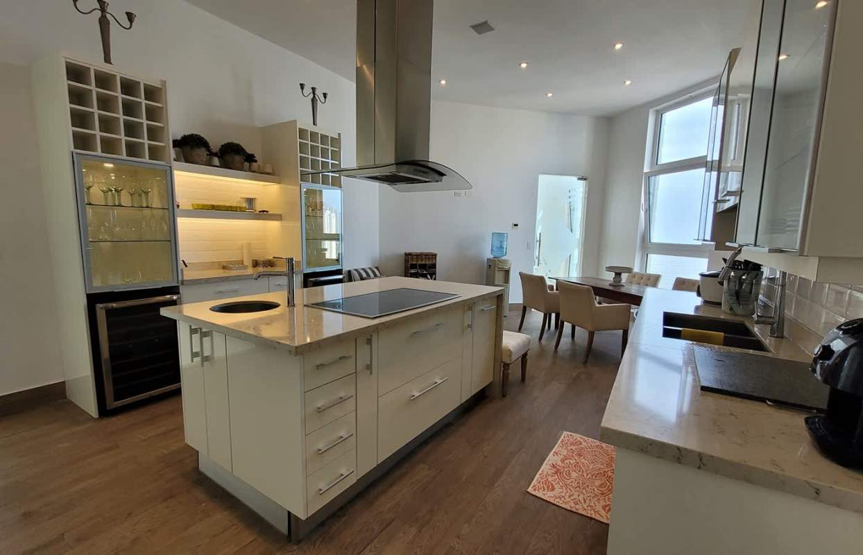 Gourmet kitchen with island, luxury appliances, dining area in Belvedere Park Penthouse Coco del Mar Panama
