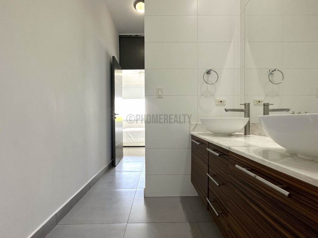 Modern bathroom with double vessel sinks, glass shower in PH Element Panama
