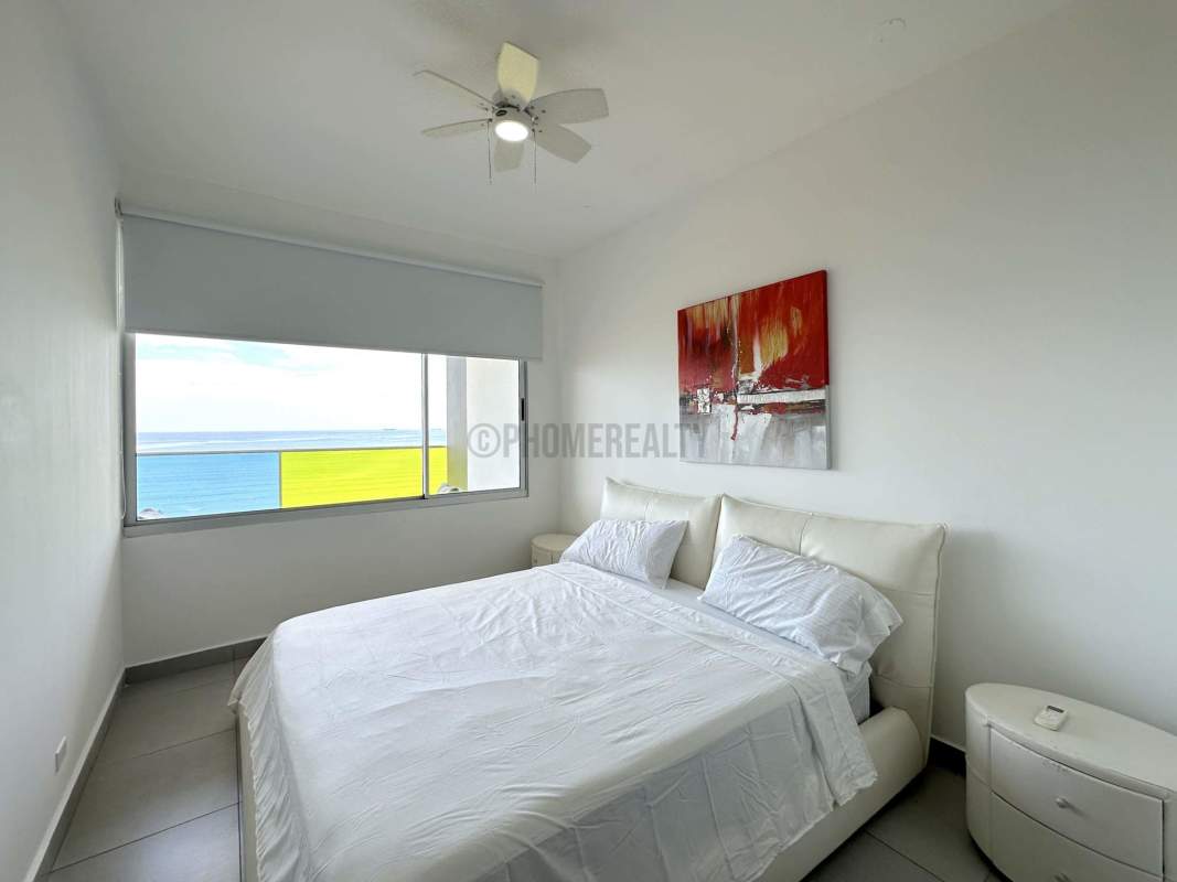 Master bedroom with king bed, ocean view windows, modern decor in PH Element Tower Panama City