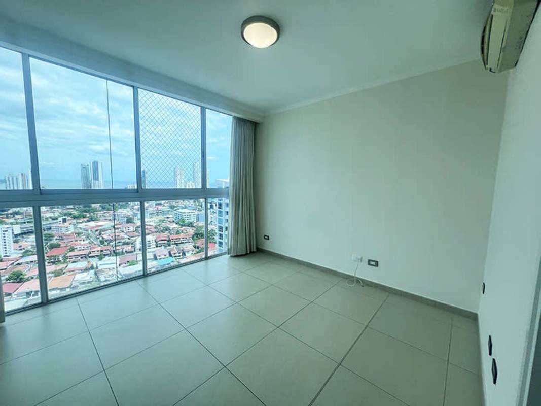 Covered balcony with panoramic skyline and ocean views in PH The Regent Tower