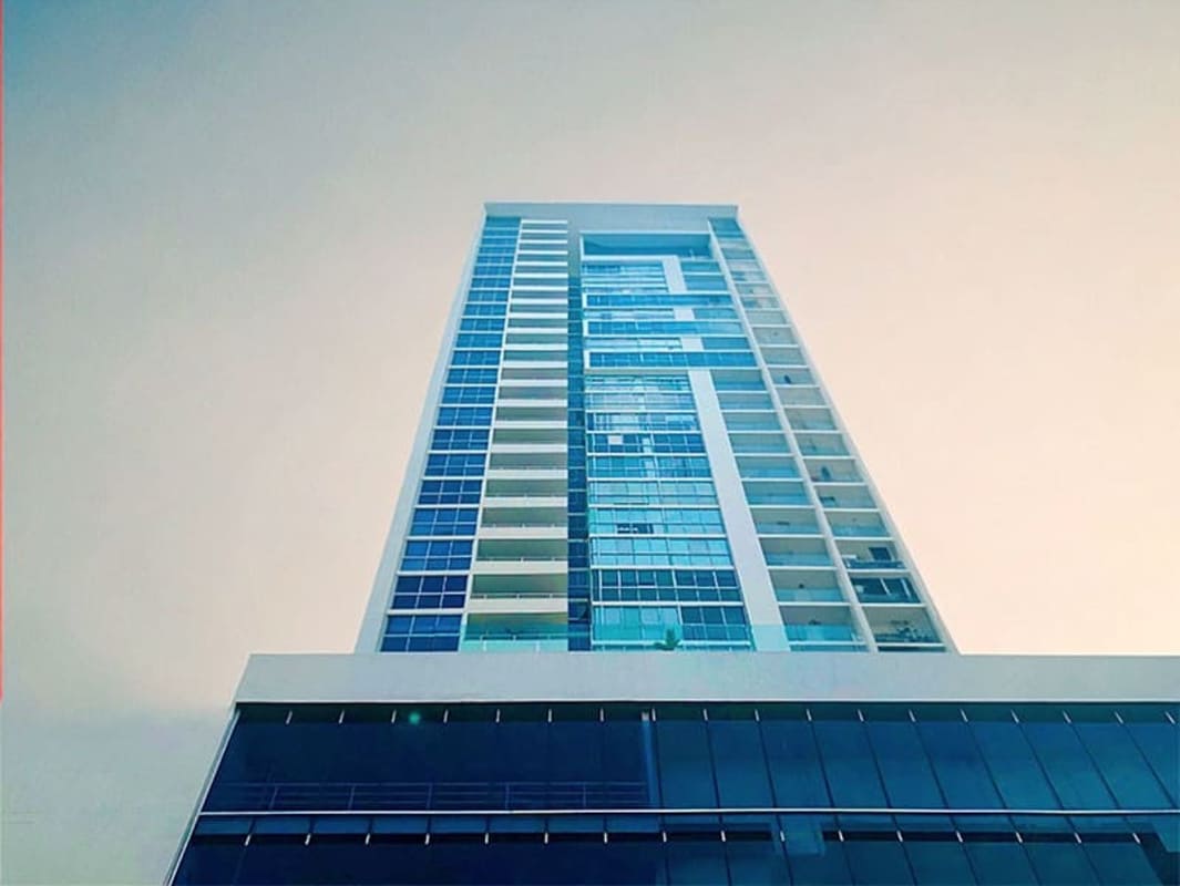 Spacious modern lobby with chandelier, seating area and glass facade at The Regent San Francisco
