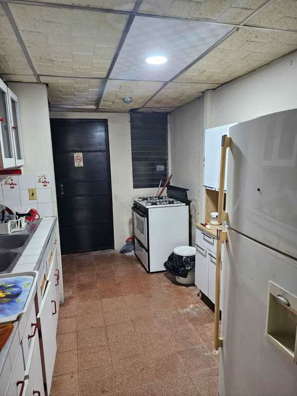 Narrow kitchen with gas stove, refrigerator, sink and storage PH Bello Horizonte Panama