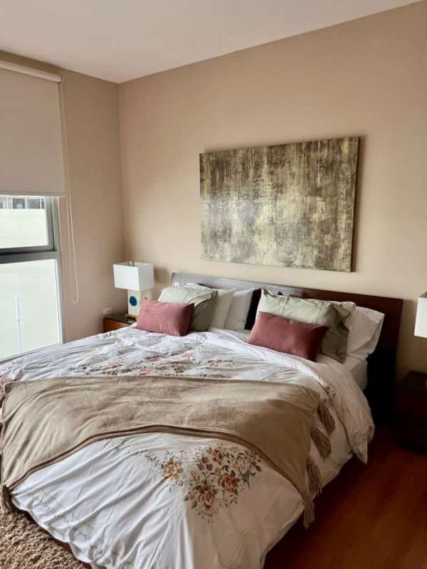 Bright master bedroom with king-size bed, large window and skyline view Punta Pacifica