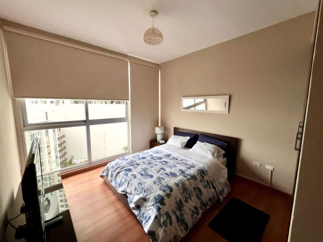 Bedroom with floor-to-ceiling windows and ocean/city view in Punta Pacifica Panama