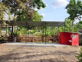 Red utility shed with ventilation blocks and sink in Santa Rosa Chilibre warehouse complex