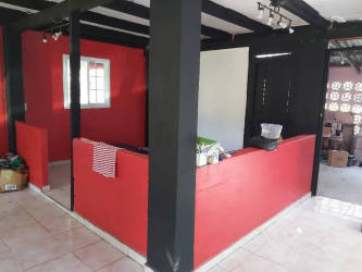 Two-story red house with driveway garden tropical style in commercial lot Chilibre Panama