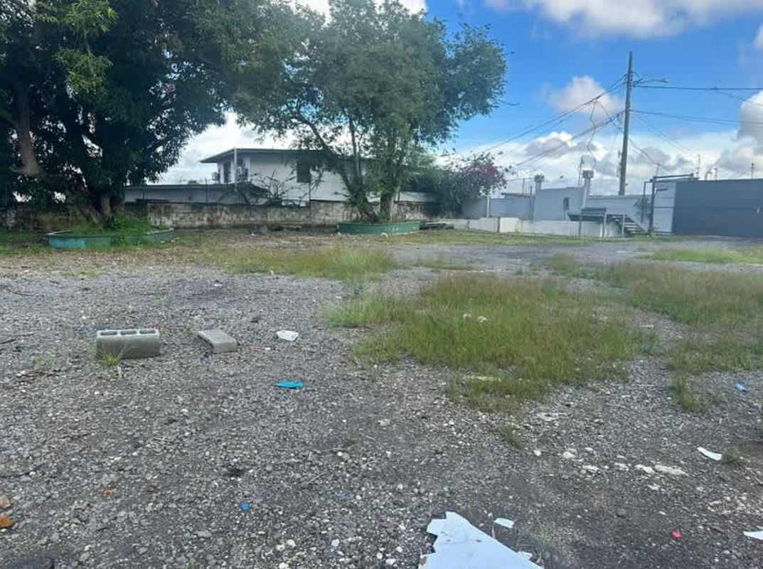 Open gravel lot with patches of grass fenced, ready for project in Parque Lefevre Panama