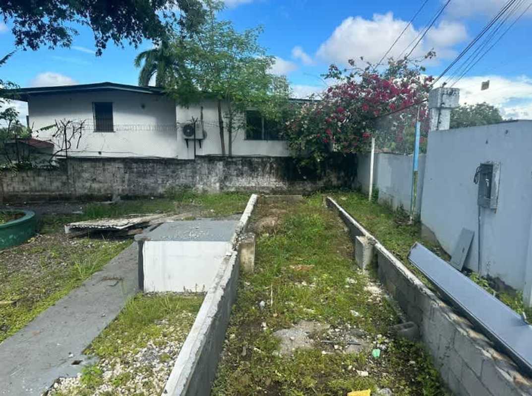 Partially developed lot with overgrown shrubs and visible foundation perimeter Parque Lefevre Panama
