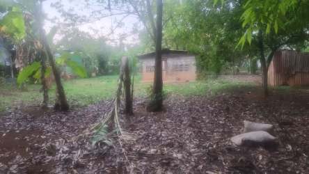 Small building in rural Panama surrounded by trees, dirt ground and fencing