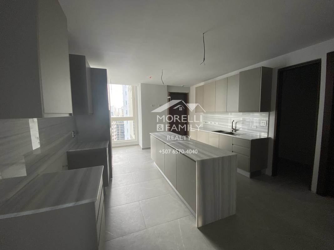 Large modern kitchen with marble island and ample storage in Punta Paitilla luxury condo