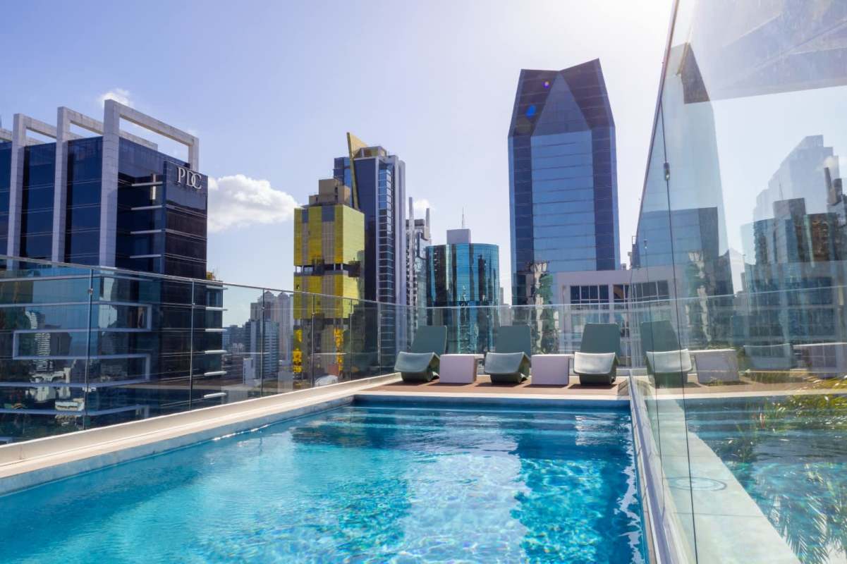 Bedroom with floor-to-ceiling windows and city skyline view in PH Mini Design Obarrio