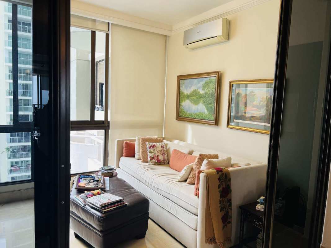 Home office or study with bookshelf, glass sliding doors, large window city view in luxury condo at Costa del Este Panama