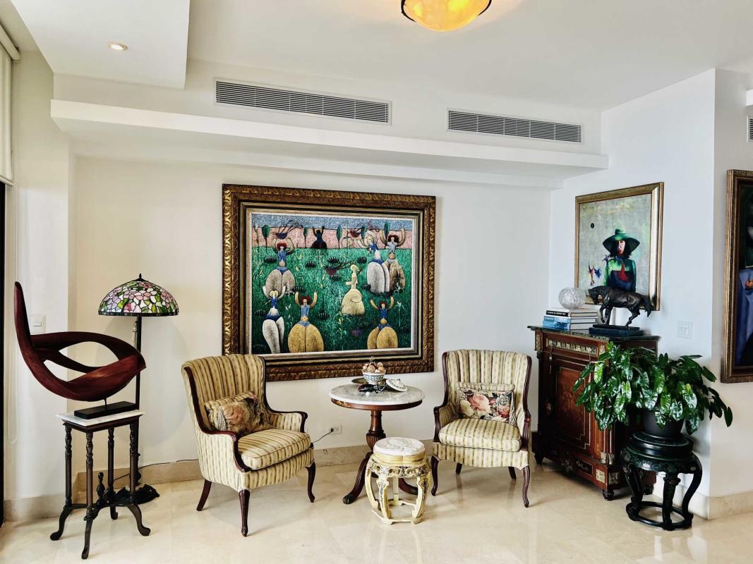 Luxury apartment living room with large windows, panoramic ocean and city views, traditional decor in Costa del Este Panama