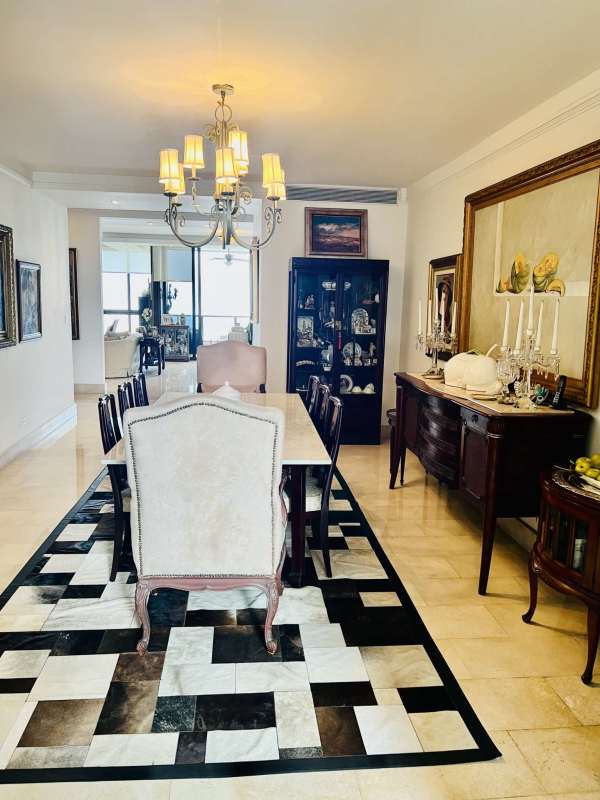 Living area with large windows, modern decor, panoramic ocean and skyline view in Costa del Este Panama City
