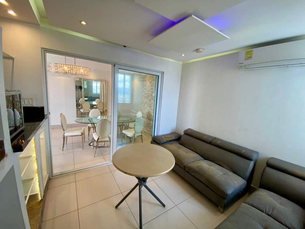 Open dining and living room with glass partition modern design Sky Point Towers Panama