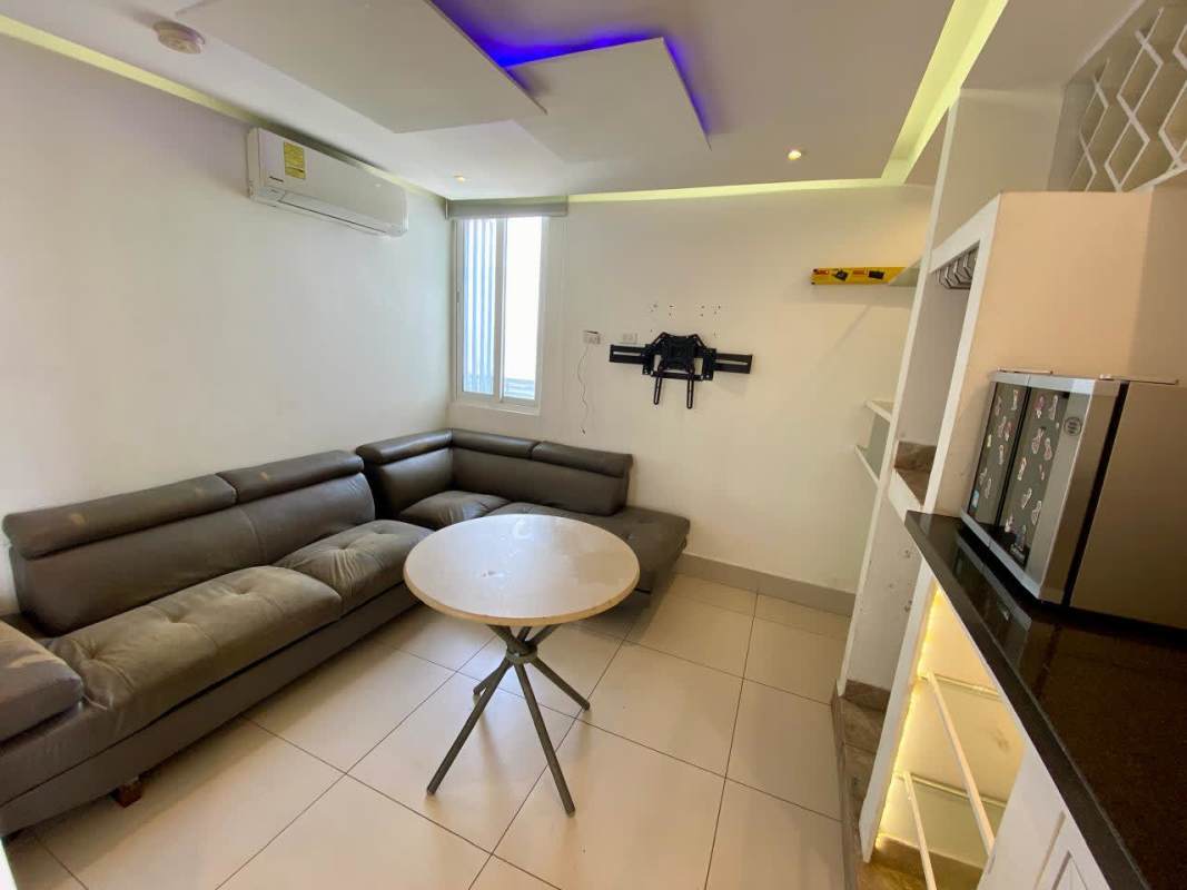 Minimalist living room with gray sofa, modern lighting, air conditioning at PH Sky Point Towers Panama