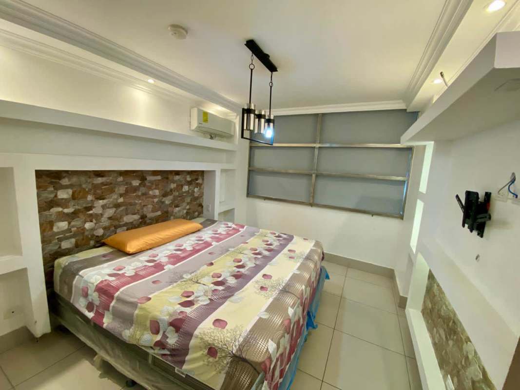 Modern bedroom with accent lighting, built-in shelving, ensuite bath PH Sky Point Towers Panama