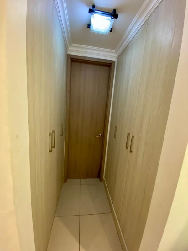 Walk-in closet with built-in light wood wardrobes PH Sky Point Towers Panama