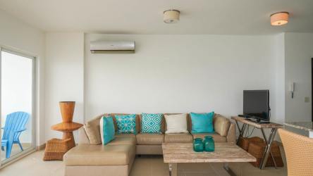 Modern kitchen with granite countertop, dark wood cabinets, stainless appliances at beachfront condo Farallón