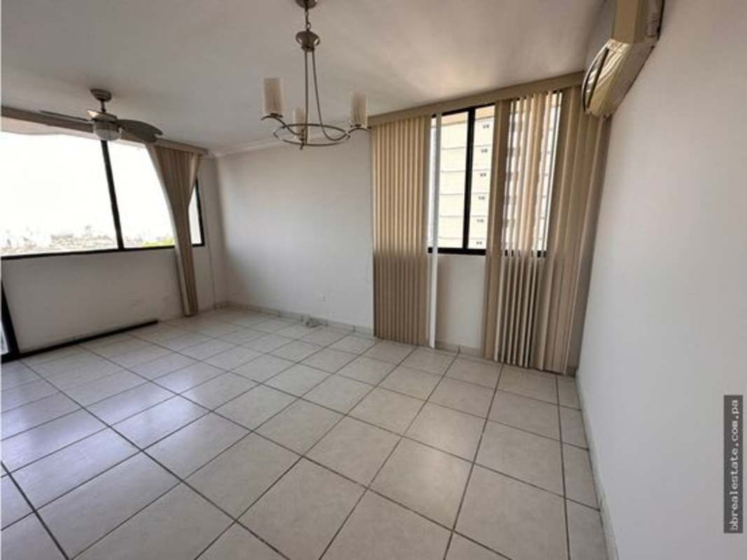 Living area with ceiling fan, tiled floors, large windows, balcony PH Fountain View Panama