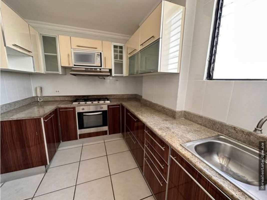 Modern kitchen with granite counters and storage in PH Fountain View Panama City