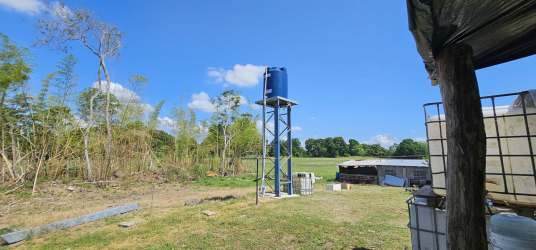 Water tank tower and shed on open farmland in Alanje, perfect agriculture lot