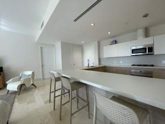 Spacious modern kitchen with large island, built-in appliances in Buenaventura beachfront condo Panama