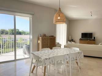 Open concept dining and living room with balcony access in Puntaarena Buenaventura Panama