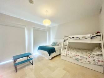 Bright second bedroom with neutral decor in Puntaarena Buenaventura beach condo Panama