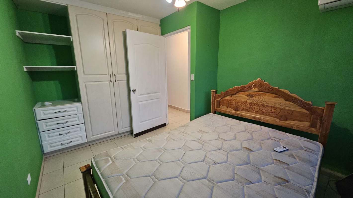 Bedroom built-in wardrobe AC fan green wall Dorado Lakes Panama