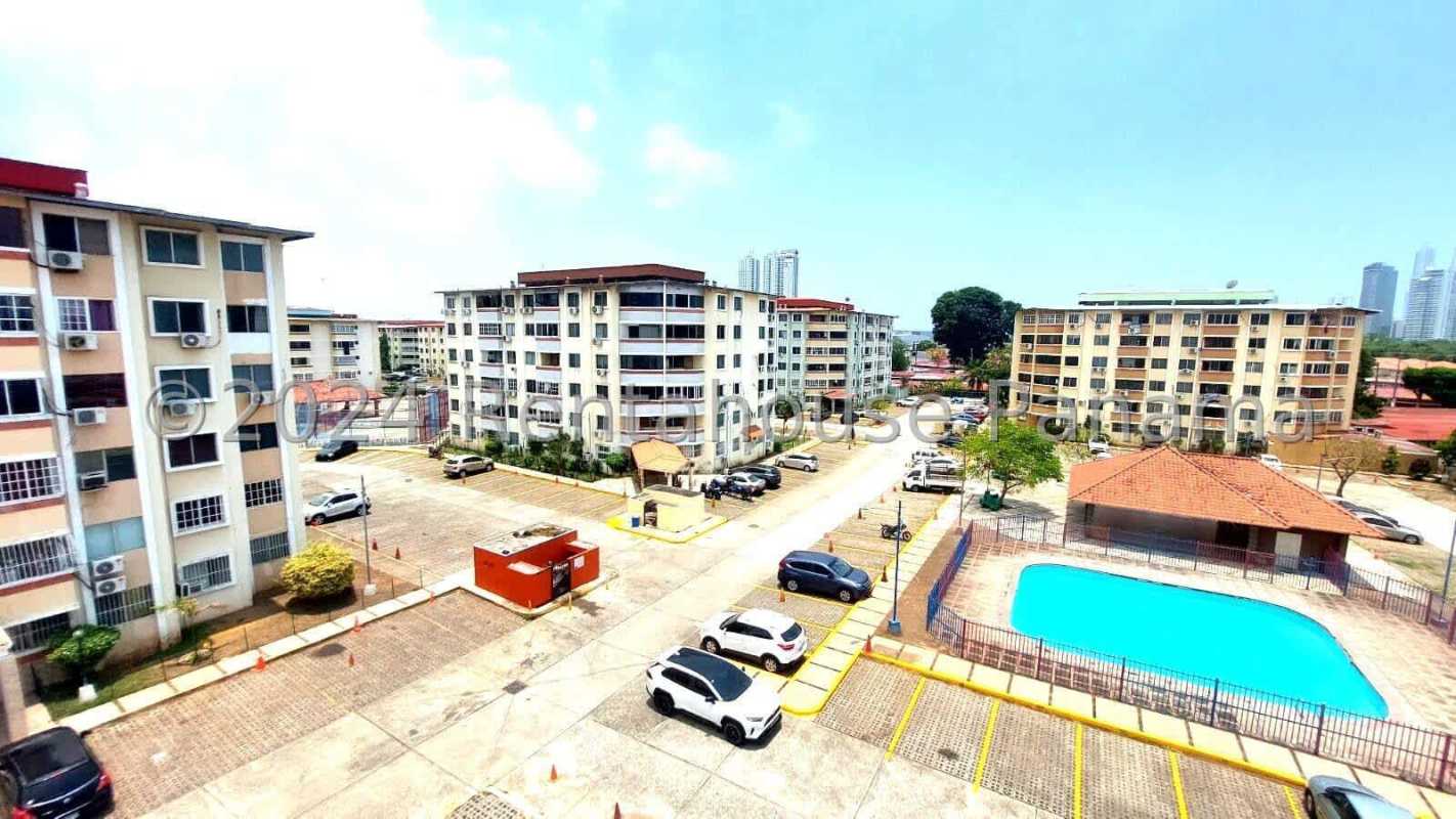 Outdoor fenced swimming pool with sun deck surrounded by apartments PH Parque del Este Juan Diaz Panama