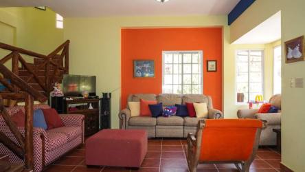 Spacious living area with split level design, natural light and colorful furnishings in Altos del María Panama