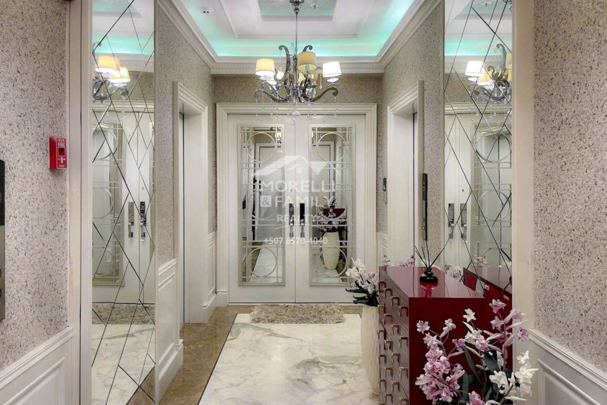 Elegant elevator lobby featuring marble floors, mirrored walls, chandelier lighting at The Point luxury tower in Panama City