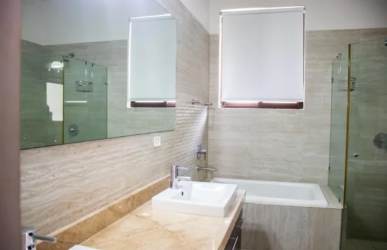 Spacious living room with staircase, glass sliding doors to garden in Nativa Panama Pacifico