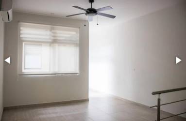 Tree-lined street with contemporary duplex houses and gardens in Nativa Panama Pacifico