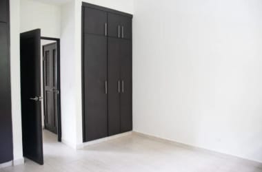 Bright interior room with large window, ceiling fan, metal railing in Nativa Panama Pacifico