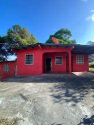 Living room with bright tile floors , neutral walls and access to bedrooms in affordable house Arraiján