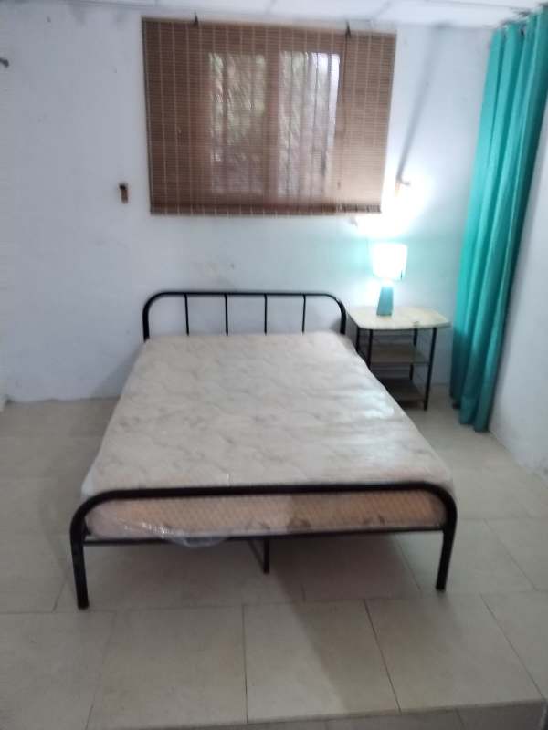 Bedroom with metal bed frame and window in loft for rent Ciudad Radial Panama City