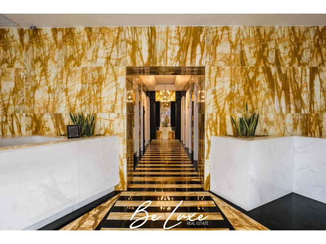 Lobby with black and gold marble walls and chandeliers PH SFC Tower Obarrio financial district