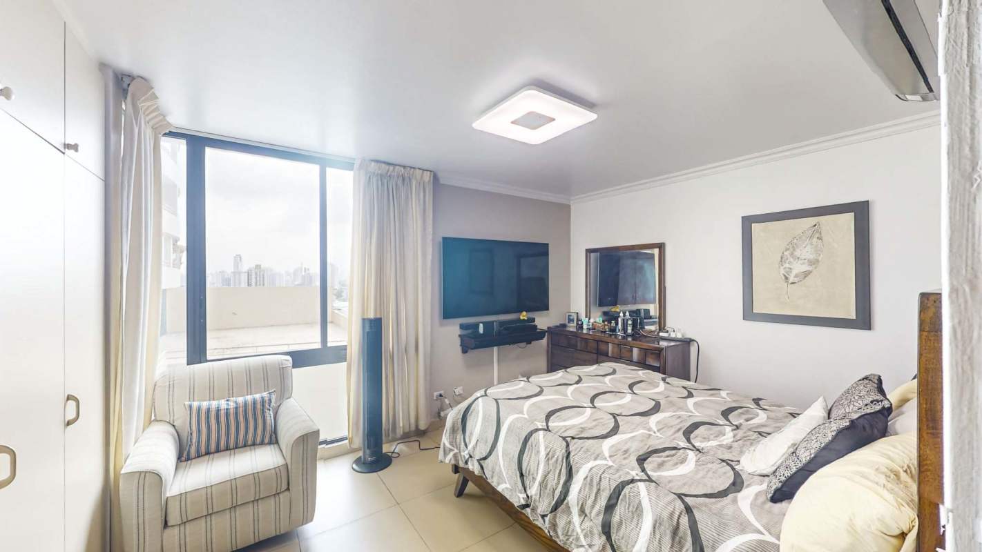Modern bedroom with built-in closet and large window Edison Park Panama