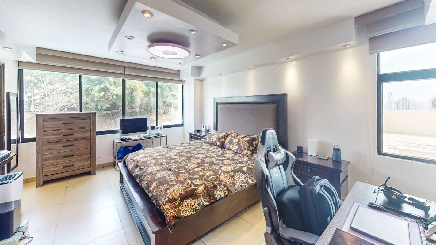 Balcony space with entertainment setup overlooking city and greenery in Edison Park Panama