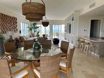 Open dining and kitchen area with panoramic windows oceanfront penthouse Buenaventura Panama