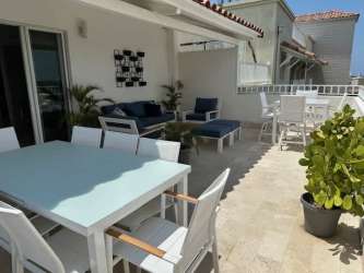 Modern bathroom with glass shower enclosure and double sink vanity in Puntarena Penthouse Panama